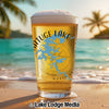 Pint glass of beer with Chatuge Lake map design on a beach.