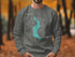 Dark gray sweatshirt with turquoise Lake Sammamish map and compass graphic.