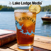 Glass of iced tea with a lemon slice, featuring a map design and text.