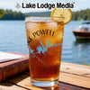Glass with iced tea and Lake Powell map design, on a wooden table.