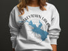 White sweatshirt with Whiskeytown Lake map design and compass rose.