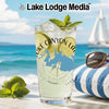Glass with beverage, lime, mint, sunglasses, and nautical compass design.
