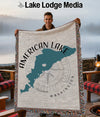 Man holds American Lake Washington map blanket with compass design.