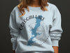Oologah Lake Oklahoma map and compass design on a light blue crewneck sweatshirt.