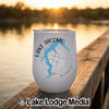 White insulated stemless wine tumbler featuring a blue map of Lake Jacomo, Missouri, resting on a wooden dock at sunset.