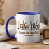 White mug with blue handle and rim, featuring "Lake Life" and "Brooks and Hess Lake Michigan" text.