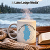 White mug with Lake Derwentwater England map design sits on a windowsill.