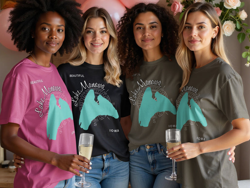 Four women wearing Lake Manawa Iowa t-shirts hold champagne flutes.