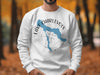 White sweatshirt with blue Lake Charlevoix map over a compass rose.
