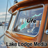 Sacandaga Life sticker on a boat window with Lake Lodge Media logo.