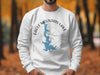 White sweatshirt with Eagle Mountain Lake, Texas graphic and compass rose.