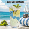 Tall glass with a refreshing drink, lime, mint, and sunglasses on a beach.