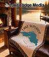 Throw blanket with Lake Superior map and "Minnesota" text on a couch.