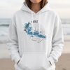 White hoodie with Rainy Lake map design and compass graphic.