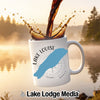 White mug with "Lake Louise" text and blue lake silhouette on compass background.