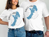 White t-shirts with blue Eagle Lake California map graphics and compass design.