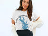 White t-shirt with blue Lake Stanley Draper map and compass graphic.
