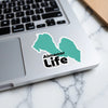 Turquoise lake outline sticker with "Almanor Life" text on laptop.