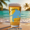 Glass of beer with Lake Simcoe map on beach background.