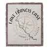Woven blanket featuring a compass rose with "Lake Francis Case South Dakota" text.
