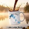 White mug with "Madison Lakes Wisconsin" and compass design, coffee pouring in.