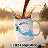 White mug with Lake Marion map and compass graphic, coffee pouring.