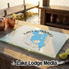 A glass cutting board featuring a blue map of Lake Kissimmee, Florida, rests on an outdoor wooden table.
