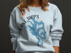 Light blue crewneck sweatshirt with Lake Tapps Washington graphic and compass design.