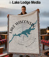Man holding a Wisconsin lake map blanket with "Lake Wisconsin" text and compass design.