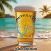 Glass of beer with "Summerville LA" and compass design on a beach.