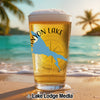 Glass of beer with "Canyon Lake" and Arizona map on beach background.