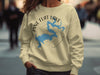 Light yellow crewneck sweatshirt with "Pine Flat Lake California" graphic and compass rose.