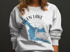 White sweatshirt with blue Hebgen Lake Montana map and compass graphic.