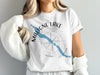 White t-shirt with Maligne Lake shape and compass design, also showing "Maligne Lake" text.