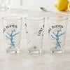 Three clear glasses with blue Lake Burton, Georgia map and compass designs.