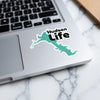Turquoise Hudson Life sticker on a laptop keyboard.