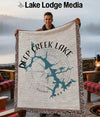 Man holding Deep Creek Lake Maryland map blanket with compass and fringe.