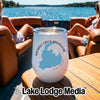 A white stainless steel wine tumbler with a map and text reading Merrill Creek Reservoir New Jersey stands on a wooden table aboard a boat.