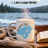 White mug with Indian Lake Ohio map design on a wooden table with a book and scarf.