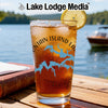 Iced tea in a glass with a map design and lemon on a wooden table.