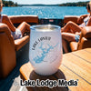 A white insulated wine tumbler with a Lake Lanier, Georgia design sits on a wooden boat table.