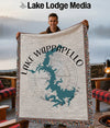 Man holding a throw blanket with a teal map of Lake Wappapello, Missouri.