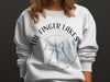 White sweatshirt with a compass and blue Finger Lakes map graphic.