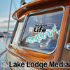 Turquoise Douglas Life sticker on boat window next to "Lake Lodge Media" logo.