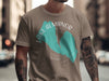 Taupe t-shirt featuring teal "Lake Almanor California" text overlaying a compass design.