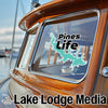 Turquoise lake outline sticker and "Pines Life" text on a boat window, with "Lake Lodge Media" text below.