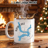 White mug with blue Kaw Lake map and compass graphic, steaming coffee.