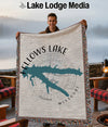 Fellows Lake Missouri map woven throw blanket held by a man outdoors.