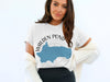 White t-shirt with Walden Pond Massachusetts graphic and compass graphic.