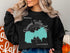 Black sweatshirt with "Diamond Valley Lake California" text and map graphic.
